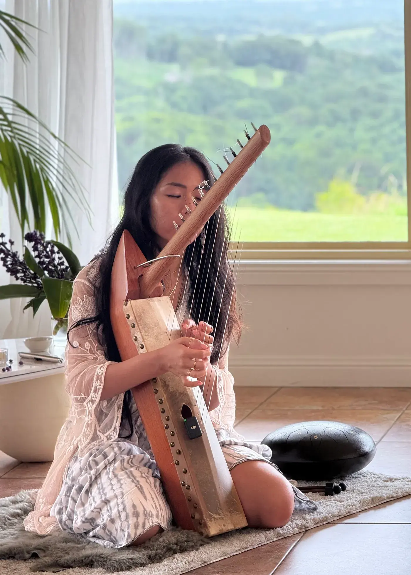Sarah playing harp at her retreat
