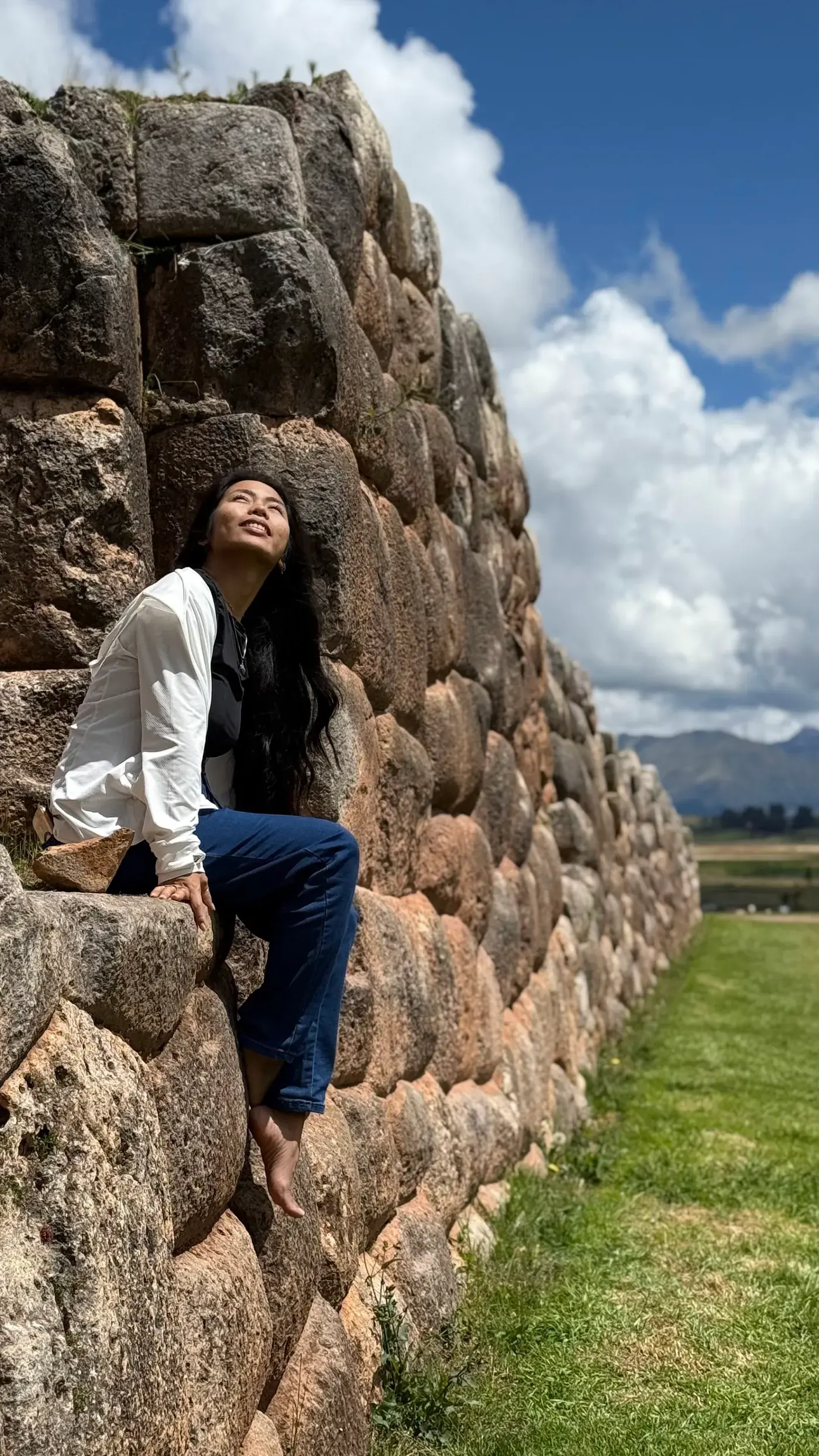 A woman standing tall in the mountains of Peru
